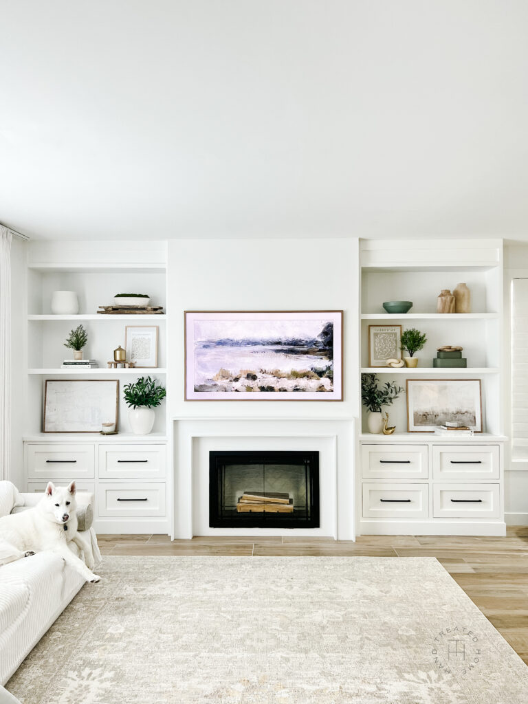 DIY built in book shelves next to an electric fireplace with tips on how to decorate shelves