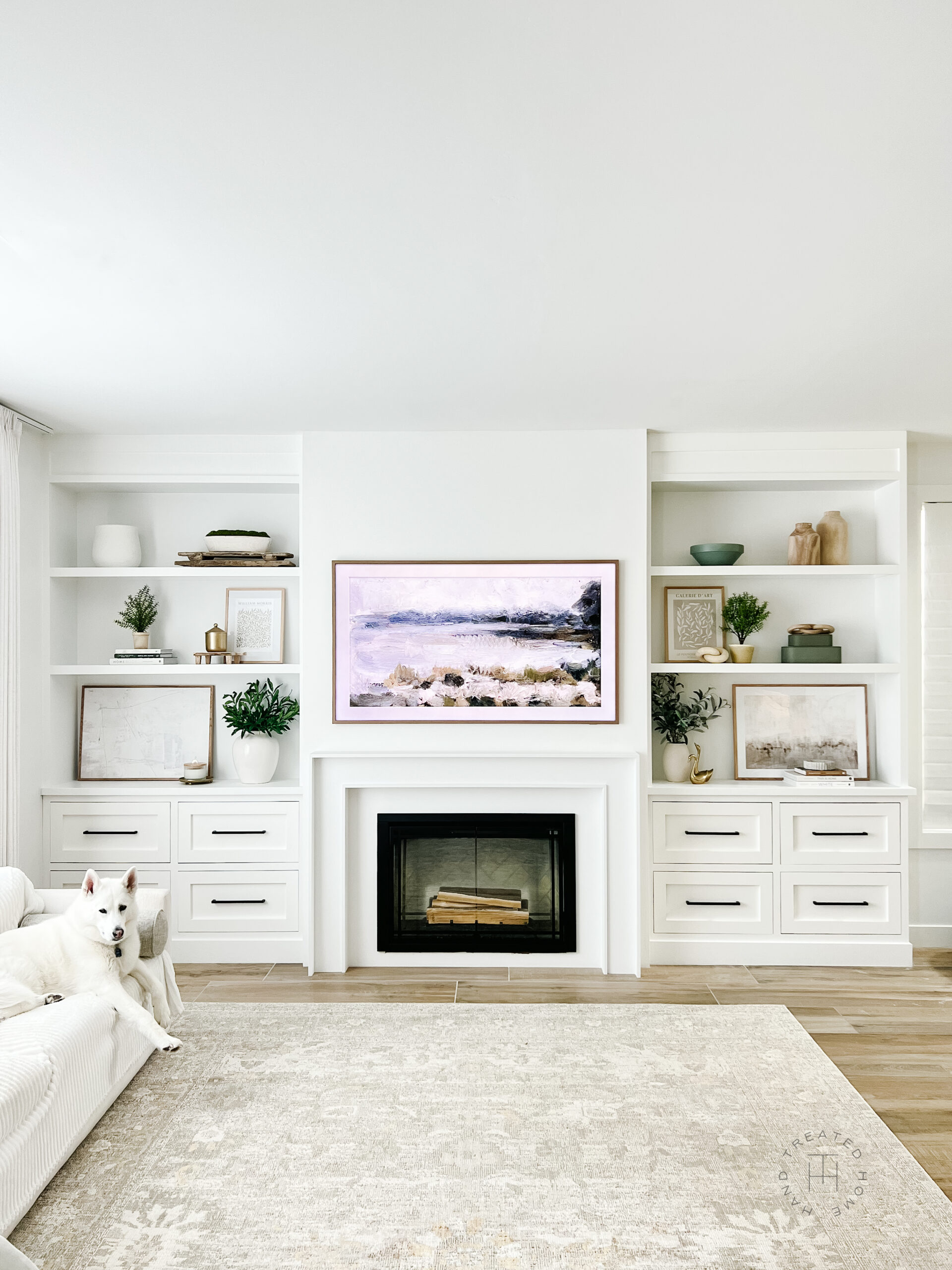 Built in shelves next to electric fireplace with decorated shelves.
